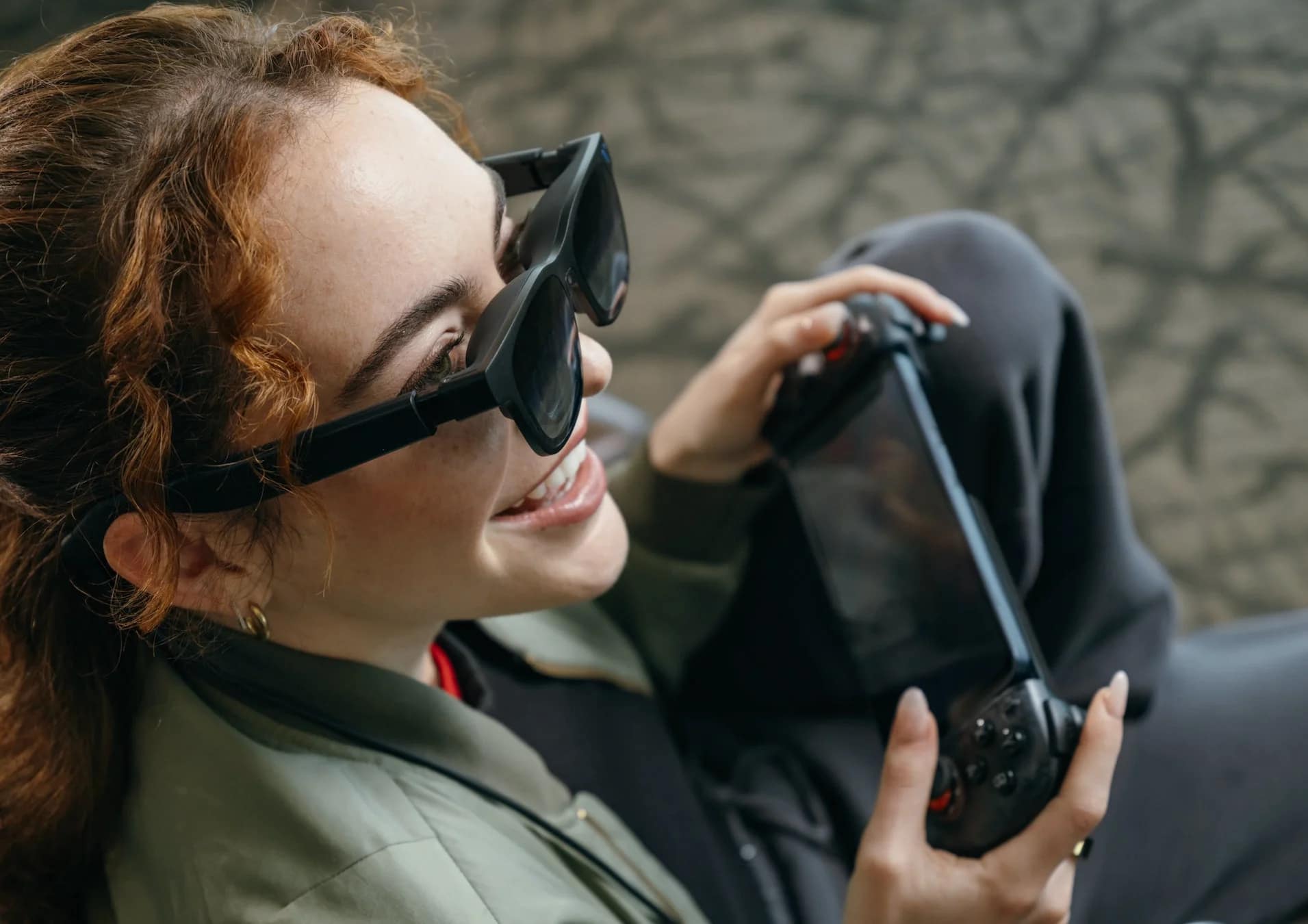 スマートグラスをかけゲーム機を操作する女性